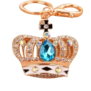 Elegant crystal crown keychain with blue teardrop gemstone and black cross charm
