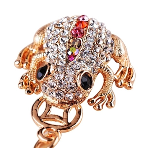 Golden toad keychain with colorful rhinestones and sparkling crystals on white background