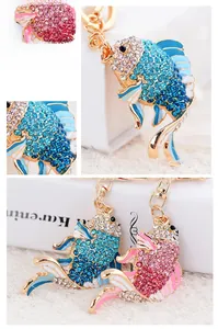 Detailed close-up of fish-shaped keychains with blue and pink rhinestones and enamel finish