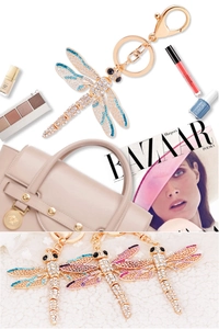 Detail of dragonfly keychain with colorful rhinestones on a beige luxury handbag