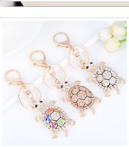 Close-up of diamond-encrusted turtle keychains in gold, champagne, and colorful crystal