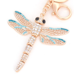 Exquisite dragonfly keychain with gold plating and blue rhinestones on white background
