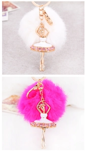 Detailed macro view of ballet dancer keychain with fluffy pom poms and pink crystals