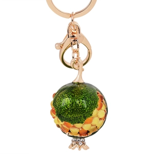 Cute golden pomegranate fruit keychain with colorful beads and rhinestone accents