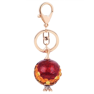 Cute pomegranate fruit keychain with red lacquer and crystal beads on a gold metal ring