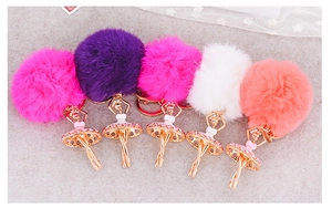 Detail of five colorful faux fur pompom ballet dancer keychains with crystal accents