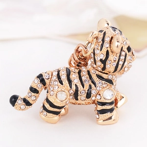 Porte-clés tigre étincelant avec finition dorée, rayures émaillées et strass blancs