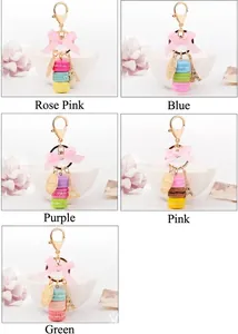 Close-up of macaron keychains with Eiffel Tower charms and silk bows in five pastel colors