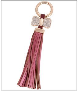 Detail view of pink leather tassel keychain with rhinestone bow and gold-tone hook