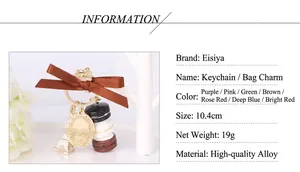 Detailed macro view of macaron charm keychain with bow and Eiffel Tower pendant