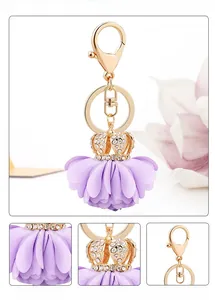 Detail of purple fabric flower keychain with crown rhinestone and gold alloy lobster clasp