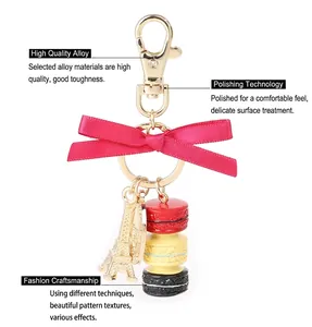 Detail of macaron keychain with silk bow and golden Eiffel Tower charm on alloy ring