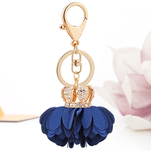 Elegant gold crown keychain with navy blue fabric flower tassel and sparkling rhinestones