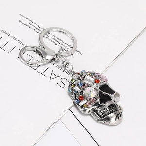 Macro shot of skull keychain with colorful rhinestones on a magazine background