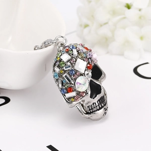 Detail shot of sparkling colorful rhinestones on a metal skull keychain pendant accessory