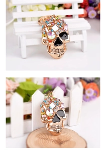 Rose gold skull keychain with colorful rhinestones and detailed vine engravings