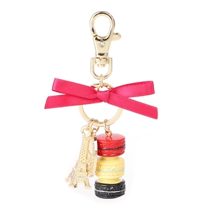 Eiffel Tower and colorful macarons keychain with a pink silk bow on a gold clasp