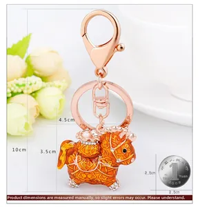 Detailed macro view of horse keychain with orange enamel and sparkling rhinestones