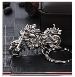 Polished silver motorcycle keychain showing 5.5cm length and 3cm height dimensions