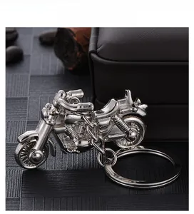 Detailed close-up of a silver zinc alloy motorcycle keychain showing intricate metal craft