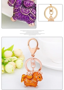 Detail of rose gold keychain with enamel horse pendant, rhinestones and faux pearls