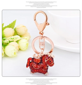 Exquisite red enamel horse keychain with gold scrolls, white diamonds and a pearl accent