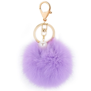 Plush purple faux fur pompom keychain with white pearl accent and golden metal clasp