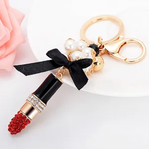 Porte-clés Forme de Rouge à Lèvres à la Mode Avec Künstliche Perle Strass Nœud en Satin Noir Pendentif Sac en Alliage Cadeau Femme