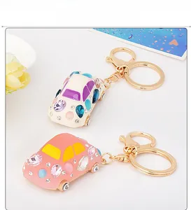 Close-up of car keychains with colorful rhinestones in cream white and pink colors