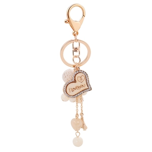 Portachiavi oro rosa con cuore in legno, ciondolo Torre Eiffel e pompon bianco