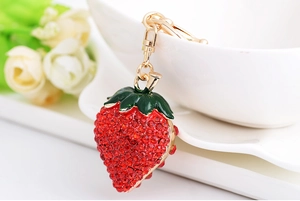 Close-up of strawberry keychain with red rhinestones and gold alloy lobster clasp