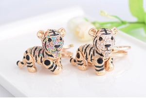 Detailed close-up of golden tiger keychain with colorful crystals and black enamel
