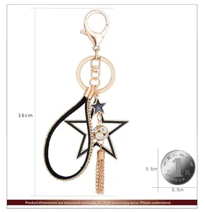 Dettaglio portachiavi a stella da 16cm con nappa dorata e sfera di cristallo lucida