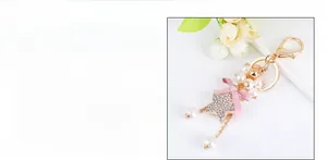Detail view of a 14cm beaded star keychain with pink satin bow and white faux pearls
