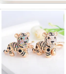 Detailed macro view of gold-plated tiger keychain decorated with colorful rhinestones