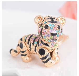 Close-up of golden tiger keychain set with vibrant multi-colored rhinestones and enamel