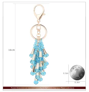 Detailed view of light blue crystal beaded tassel keychain with gold lobster clasp 16cm