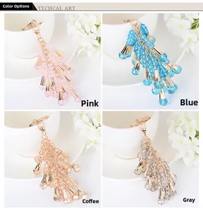 Detail view of crystal beaded tassel keychains in pink, blue, coffee, and grey colors