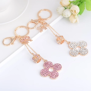Elegant rhinestone flower and crown keychain pendant in gold finish for handbags