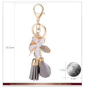 Detailed view of flower and tassel keychain with lobster clasp showing 15.5cm total length