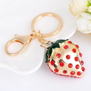 Exquisite gold-plated strawberry keychain with red crystals and green enamel leaf detail