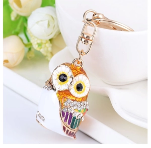 Detailed shot of an owl keychain with colorful enamel and sparkling rhinestones