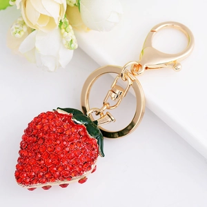 Chic alloy strawberry keychain with red rhinestones and green leaves on gold plating