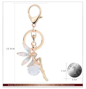 Detail of angel fairy keychain with blue enamel wings and sparkling white crystals