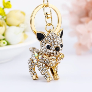 Detailed close-up of a crystal-studded bulldog keychain with gold plating and black accents