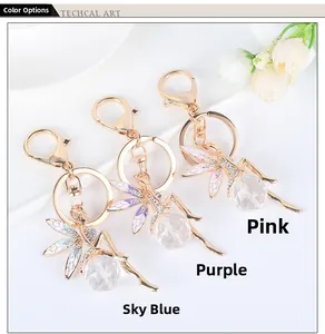 Close-up of angel crystal keychains in pink, purple and sky blue with rhinestone wings