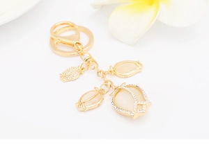 Detailed view of golden tulip keychain with opal stones and sparkling rhinestone borders