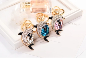 Detail of dolphin keychain charms with inlaid rhinestones and water drop stones
