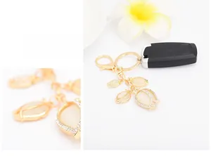 Macro detail of tulip keychain showing opal petals, gold plating and sparkling crystals
