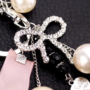 Elegant pearl and rhinestone bow keychain with pink ribbon and heart pendant